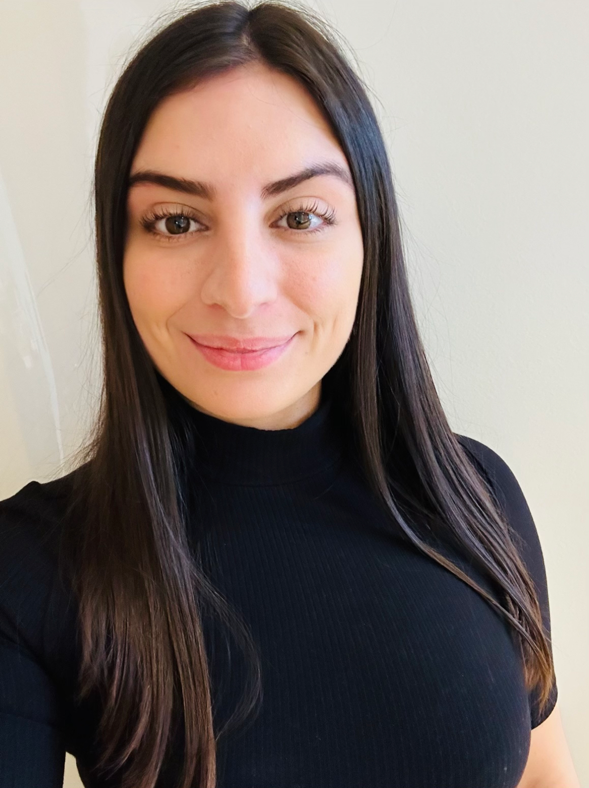 Alanna Azzopard, Biov8's Registered Nurse, is smiling in a medium close-up shot, wearing a black dress.