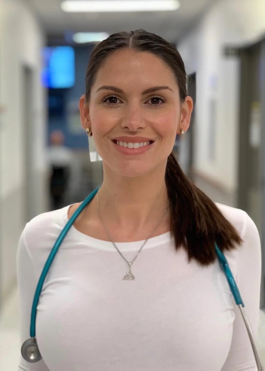 Virginia Moore, Biov8's Longevity health specialist, is smiling in a medium close-up shot with a stethoscope.